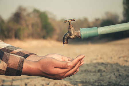 Hand for drinking water to live through drought, Concept drought and crisis environment.